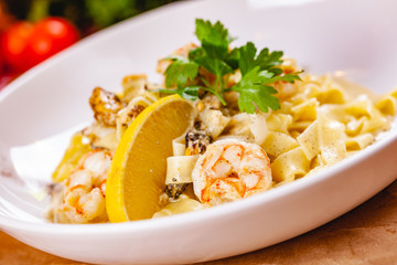 Italian pasta with seafood on white plate. Close up