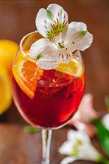Aperol spritz cocktail decorated with flower. Close up