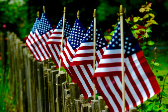 American flaf on wooden fence