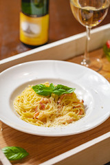 Italian spaghetti Carbonara with bacon and cheese on white plate. Close up