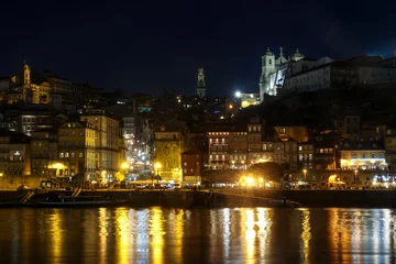 Foto op Plexiglas night panorama of city centre skyline of porto, portugal with Clérigos Tower in centre and light reflections on douro river © c-foto