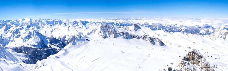Fototapeta na wymiar Panoramic landscape Winter view from the top of Kitzsteinhorn mountain on snow covered slopes, blue sky. Kaprun ski resort, National Park Hohe Tauern, Austrian Alps, Europe.