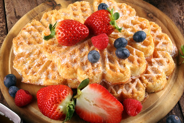 Waffle. Traditional belgian waffles with fresh fruit and powder sugar on wood