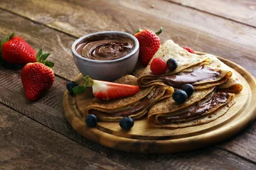 Foto op Plexiglas Delicious Tasty Homemade crepes with chocolate or pancakes with raspberries and blueberries on rustic wood © beats_