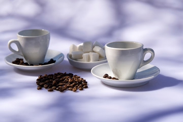 White cup for coffee, sugar and pink flower