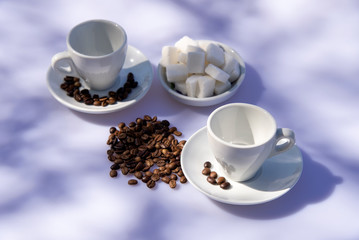 White cup for coffee, sugar and pink flower