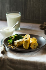 Crepes or classic russian blini with mashed potatoes, boiled broccoli and pine nuts