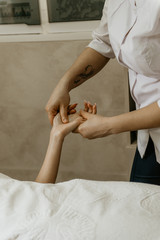 Obraz na płótnie Canvas Masseur professional makes hand massage to young woman.