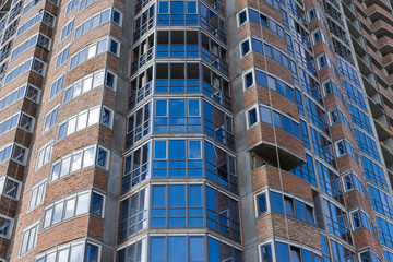 new building multistoried concrete house with brick walls and glass windows