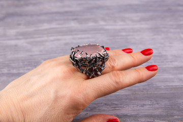 A ring with rose quartz on a hand
