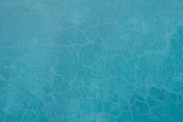 Obraz premium Background of old cracked plaster painted in blue