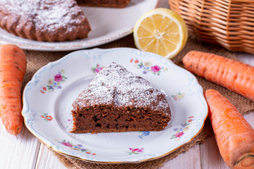 Chocolate cake with carrots in a bowl on a wooden table