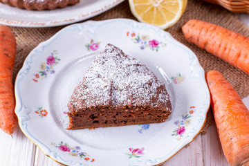 Chocolate cake with carrots in a bowl on a wooden table