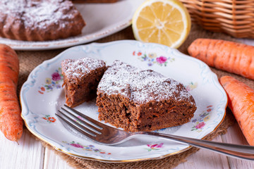 Fototapeta na wymiar Chocolate cake with carrots in a bowl on a wooden table