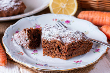 Chocolate cake with carrots in a bowl on a wooden table