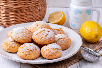 Plate with homemade lemon cookies on wooden table