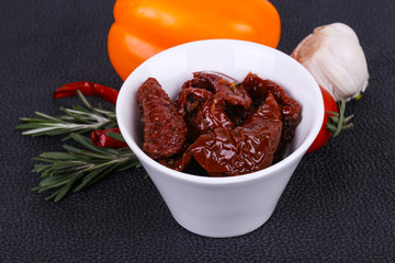 Dried tomatoes in the bowl with olive oil