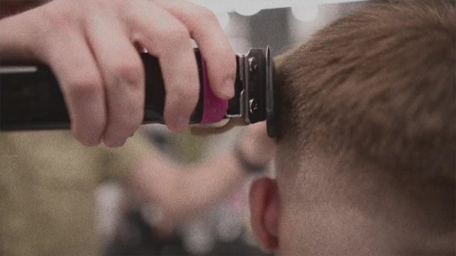  Men's haircut in barbershop. Male hair care. Video is a vintage noise filter. An old filter.