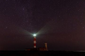 Naklejka na ściany i meble lighthouse in north fuerteventura at night