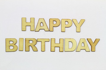 Fototapeta premium Happy birthday written with wooden letters on white surface