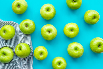 food pattern with green apples on blue background top view
