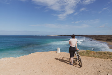 Girl wathing the waves in the ocean