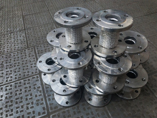 Bellows axial flange sylphon compensators. Metal sylphon compensators on the factory metal floor