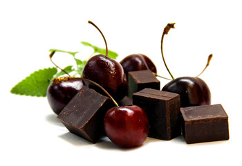 black  chocolate lump and dark large cherry isolated on white