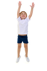 A little boy in a clean white T-shirt is jumping fun.