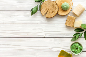 herbal organic cosmetic set for homemade spa on white wooden background flatlay mock-up
