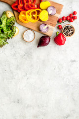 Fresh food ingredients for vegetarian kitchen on white stone background top view mock-up