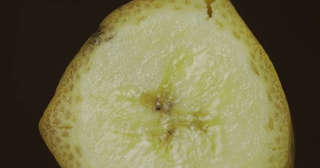 Rotate of banana piece on a dark background