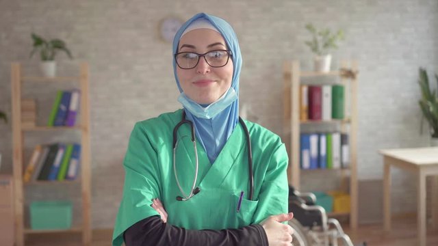 Portrait of muslim woman in hijab doctor removes bandage smiling and looking at camera