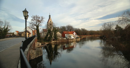 Fototapeta na wymiar View over Saale river with Church Saint Thomae in Merseburg, Germany