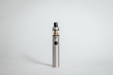 Silver e-cigarette on a gray background. Concept of smoking cigarettes, quitting smoking cigarettes. Health damage caused by smoking. Problems with the lungs, lung cancer.