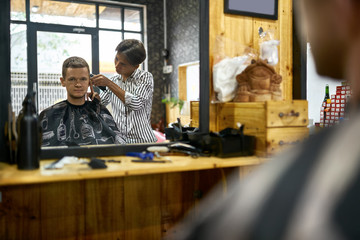 Fototapeta na wymiar Man is cutting his hair in asian barbershop