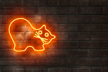Neon lamps in the form of cat on a brick wall.