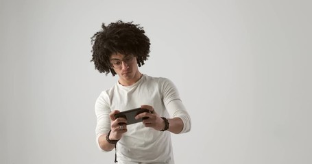 Excited man playing game on mobile phone and celebrating success