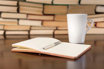 open notebook and cup  on the desktop
