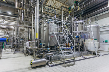Modern brewery interior. Filtration vats, pipeline, valves and other equipment of beer production...
