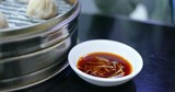Chinese steamed meat dumpling with sour ginger sauce