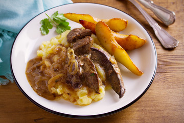 Liver with pears and cream and wine onion sause on mashed potato. horizontal
