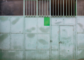 green door of a factory hall made of metal