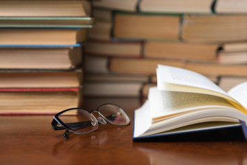 open book on the table against the background of books