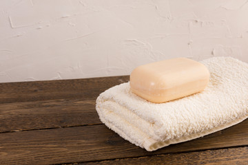 Obraz na płótnie Canvas soap and towel on a wooden shelf in the bathroom. Interior of bathroom.