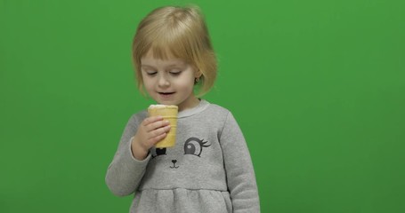 Kid girl eat ice cream on a Green Screen, Chroma Key