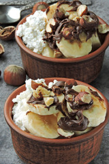 Cottage cheese with banana and hazelnuts. Healthy breakfast or snack. Keto diet.