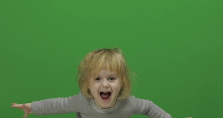 Kid girl on a Green Screen, Chroma Key. Happy three years old girl