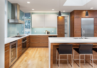 Contemporary Kitchen in New Luxury Home with Beautiful Hardwood Cabinets and Floors, and Counter to Ceiling Backsplash