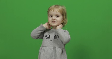 Kid girl on a Green Screen, Chroma Key. Happy three years old girl